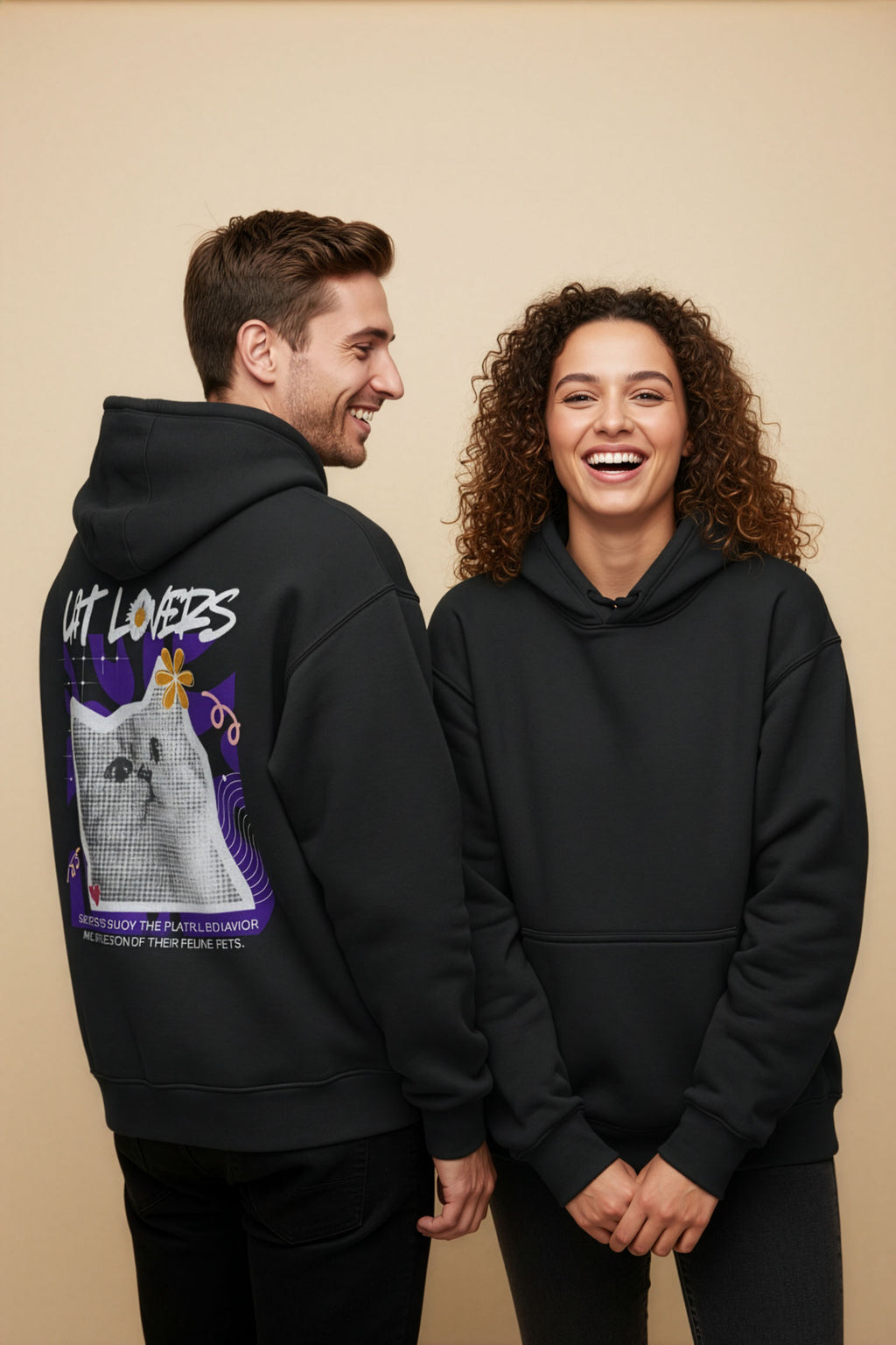 Two people wearing black hoodies with a cat graphic and 'Cat Lovers' text on a beige background