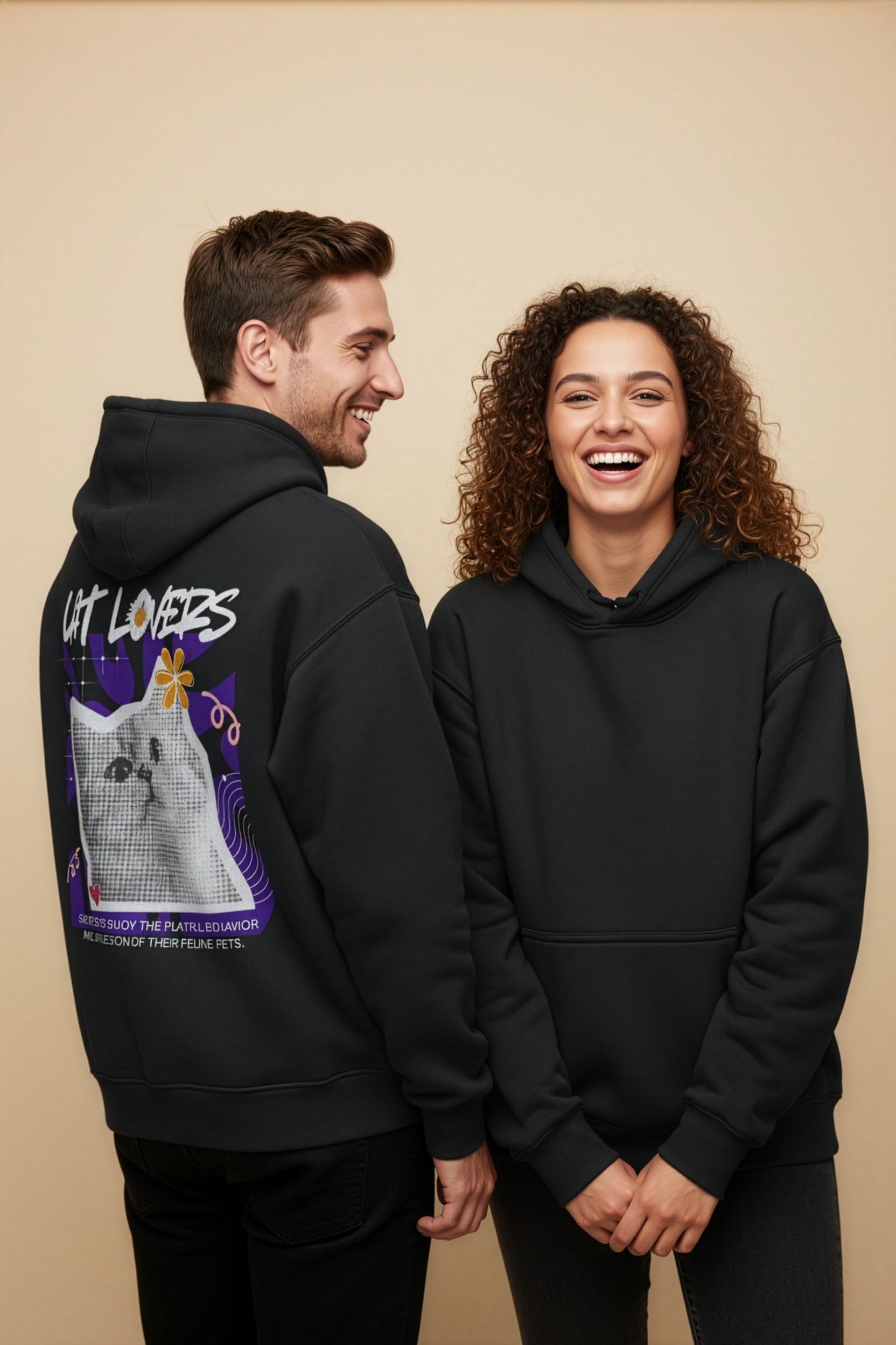 Two people wearing black hoodies with a cat graphic and 'Cat Lovers' text on a beige background