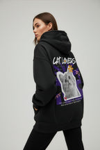 Person wearing a black hoodie with a cat-themed design on the back, on a plain background