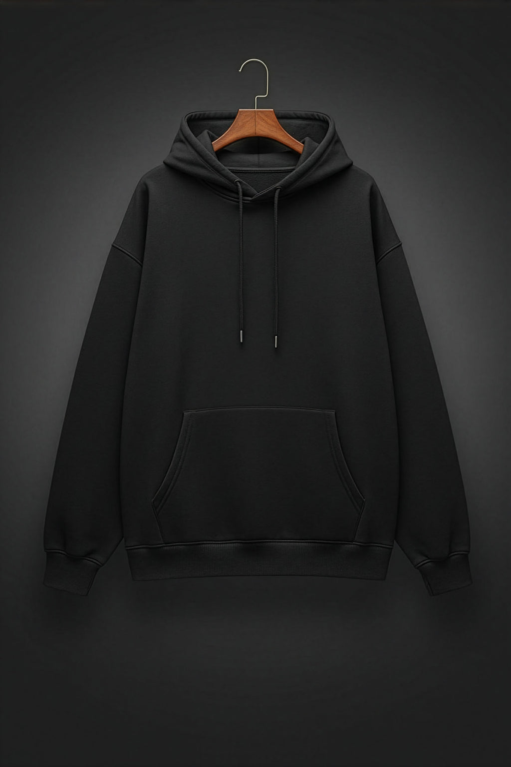 Black hoodie on a wooden hanger against a dark background